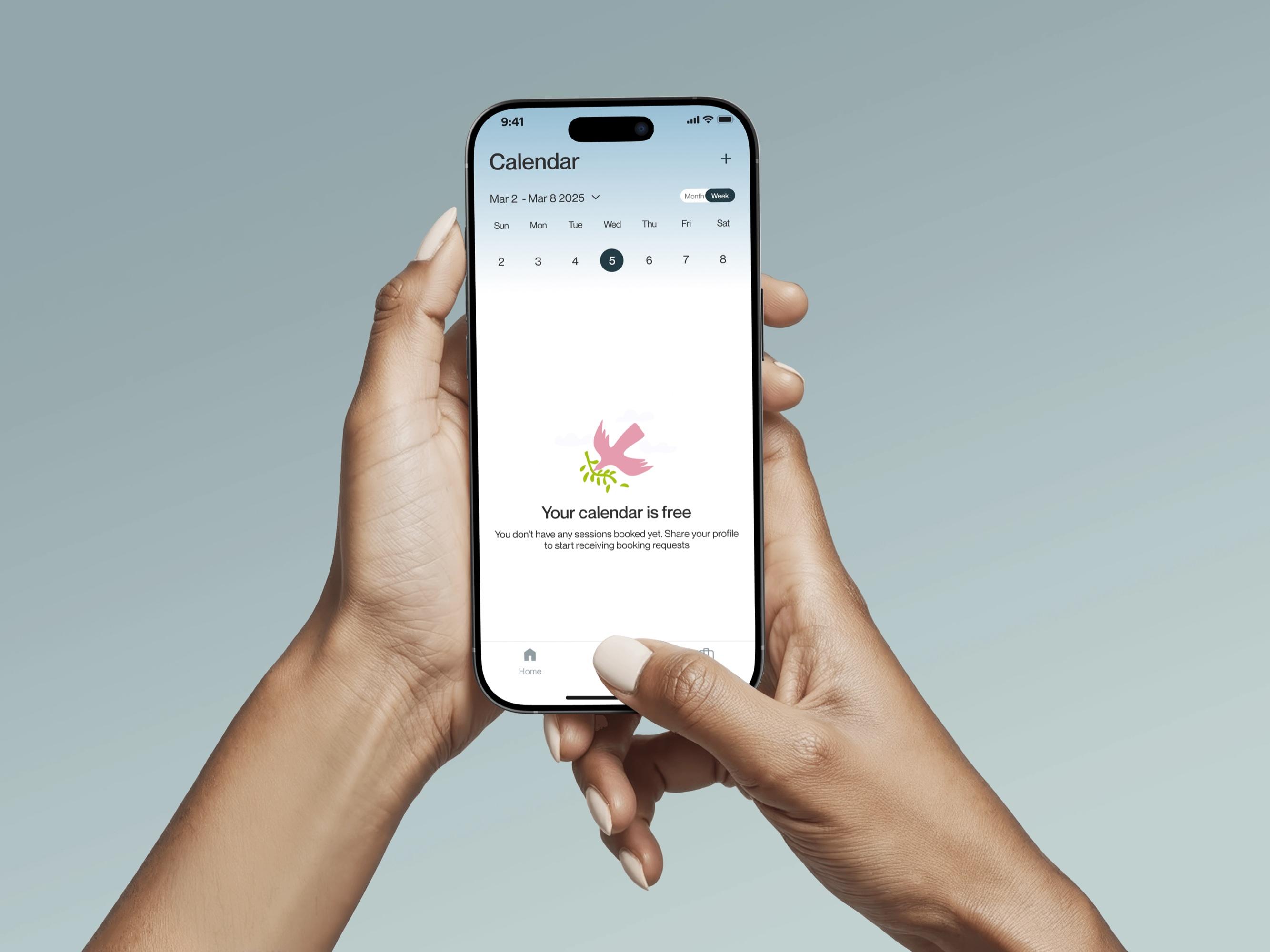 Hands holding a phone showing the OOMA calendar
